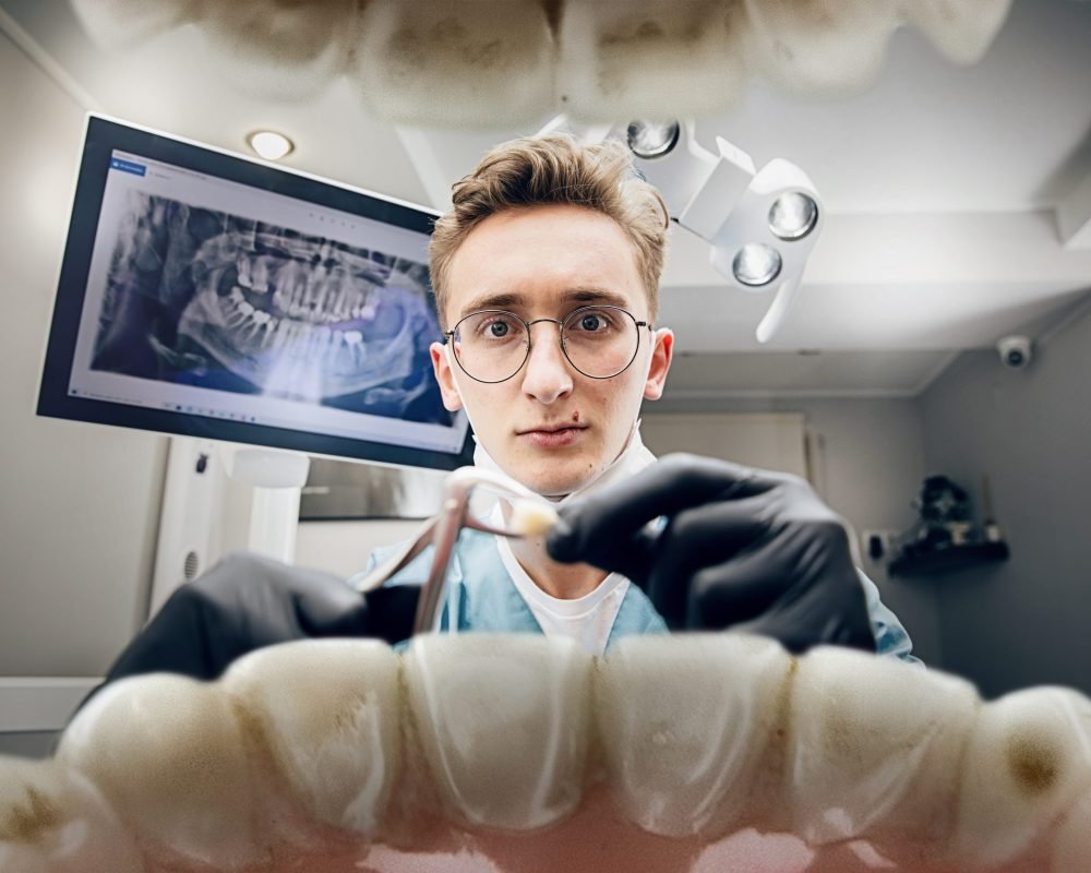 Doctor looking into the mouth, checking, examining teeth Holding teeth. Doctor looking into mouth, checking, examining teeth. Using professional tools and equipments. Healthcare and medicine, stomatology, feelings of patient. Look from inside the teeth.